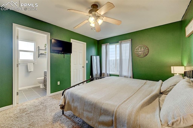 carpeted bedroom featuring connected bathroom and ceiling fan