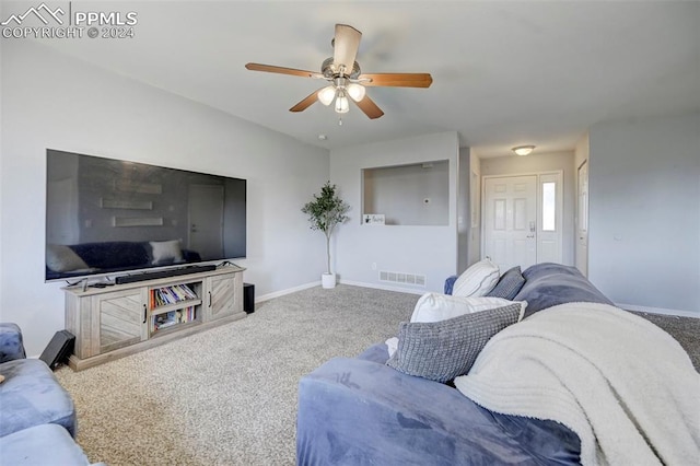 living room with ceiling fan and carpet floors