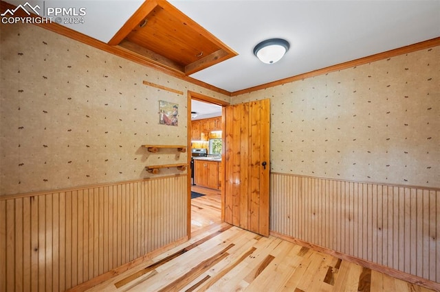 interior space with light wood-type flooring and wooden walls