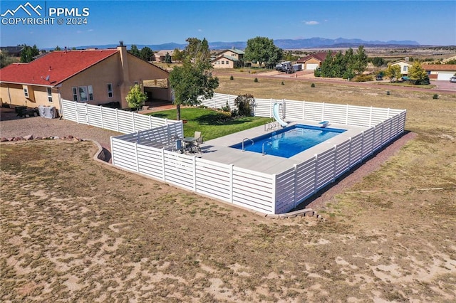 view of swimming pool with a mountain view