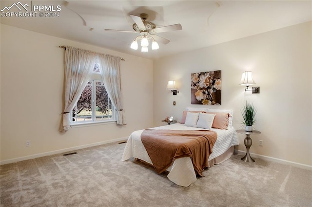 bedroom with ceiling fan and light colored carpet