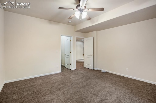 unfurnished bedroom featuring dark colored carpet and ceiling fan