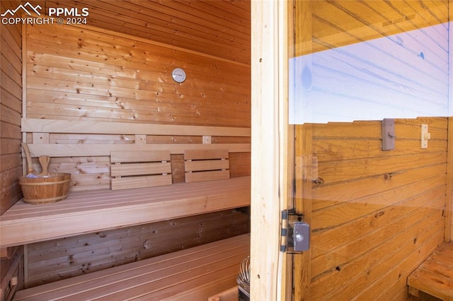 view of sauna featuring wood walls