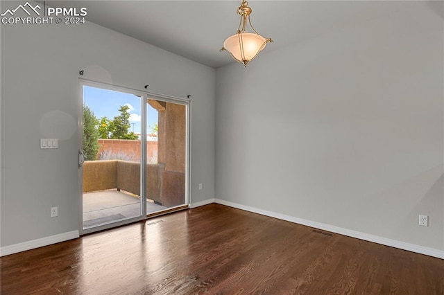 spare room with dark wood-type flooring