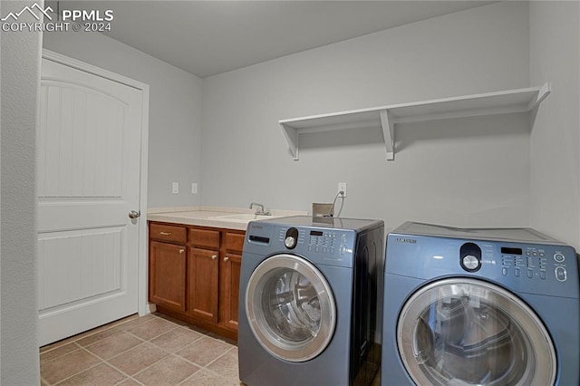 washroom with cabinets, separate washer and dryer, and light tile patterned floors