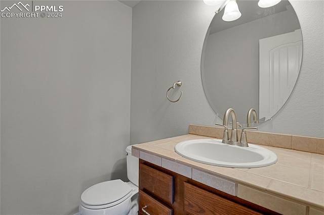 bathroom featuring toilet and vanity