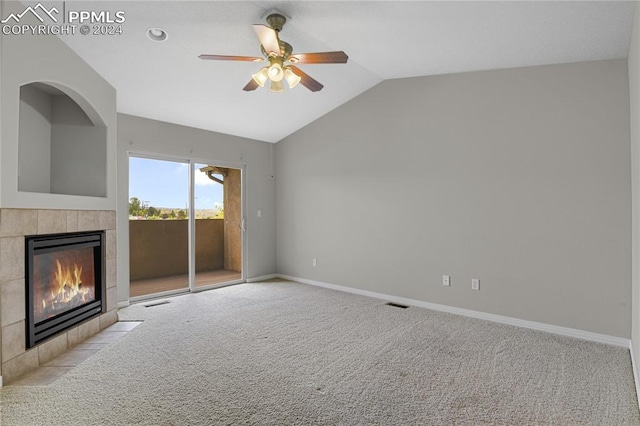 unfurnished living room featuring lofted ceiling, ceiling fan, light carpet, and a fireplace