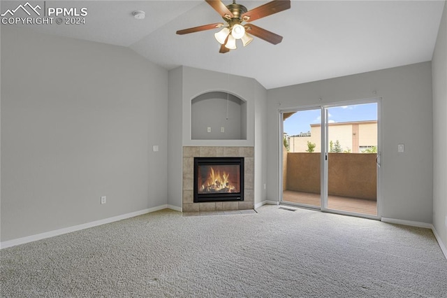 unfurnished living room with lofted ceiling, light colored carpet, ceiling fan, and a tile fireplace