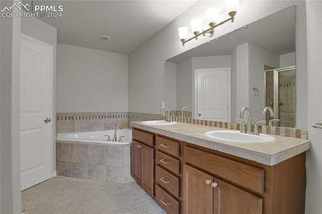 bathroom with vanity and shower with separate bathtub