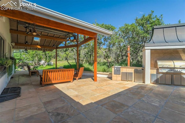 view of patio with area for grilling, ceiling fan, a grill, and a gazebo