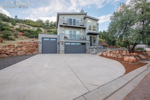 contemporary home featuring a balcony and a garage