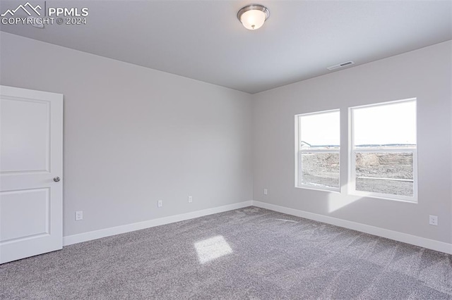 unfurnished room featuring carpet flooring