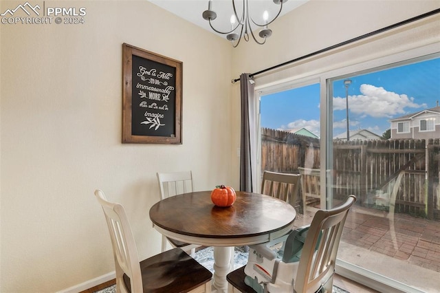 dining space with a wealth of natural light and a chandelier