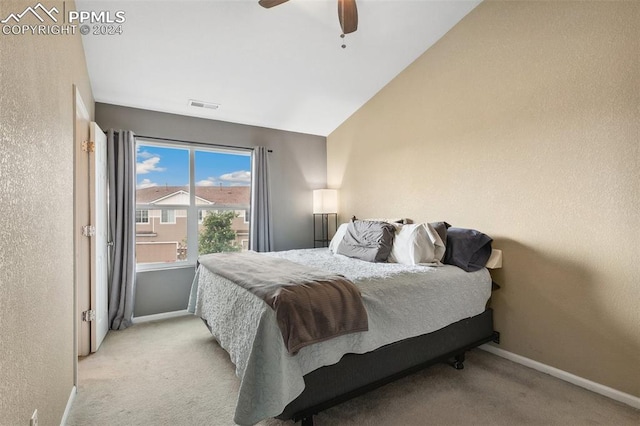 bedroom featuring vaulted ceiling, light carpet, and ceiling fan