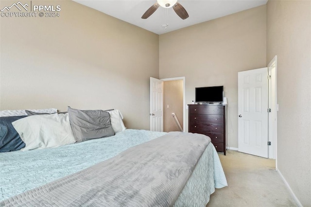 bedroom featuring light colored carpet and ceiling fan