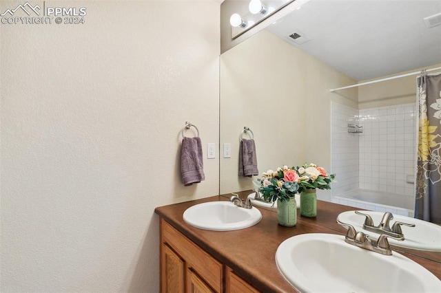 bathroom with shower / bath combination with curtain and vanity