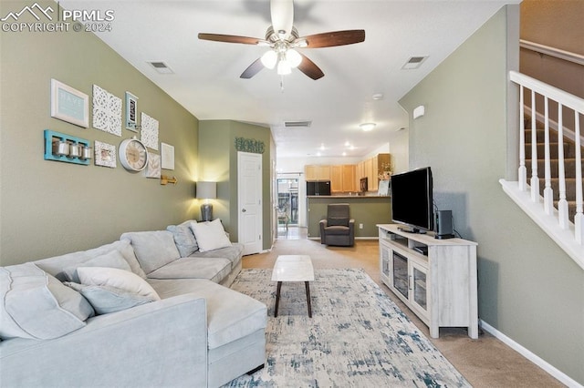 carpeted living room featuring ceiling fan