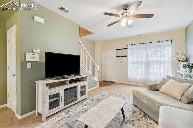 living room with light carpet and ceiling fan