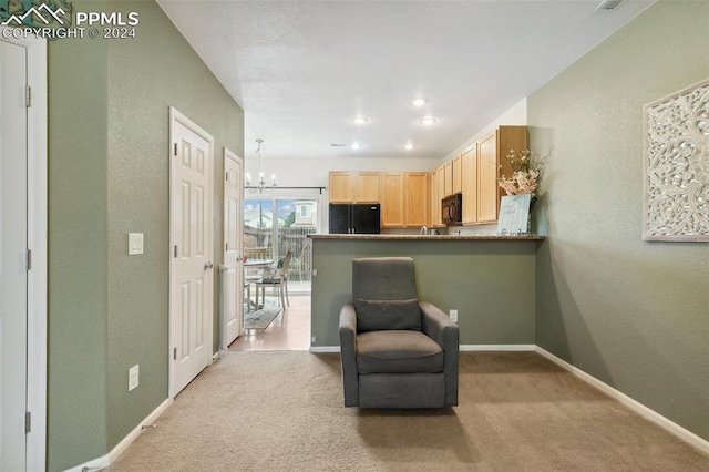 sitting room with a chandelier and light carpet