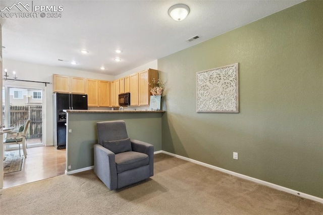 sitting room featuring light colored carpet and a notable chandelier