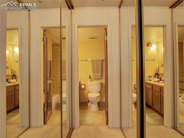 interior space with vanity, toilet, and a tile shower