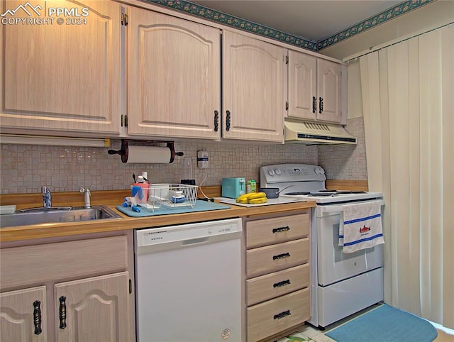 kitchen with white appliances, sink, light brown cabinets, and decorative backsplash