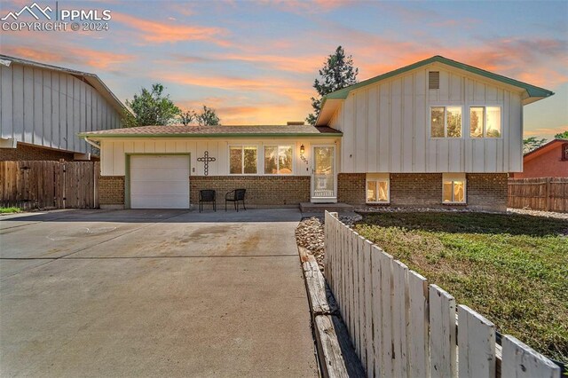 split level home featuring a garage and a front yard