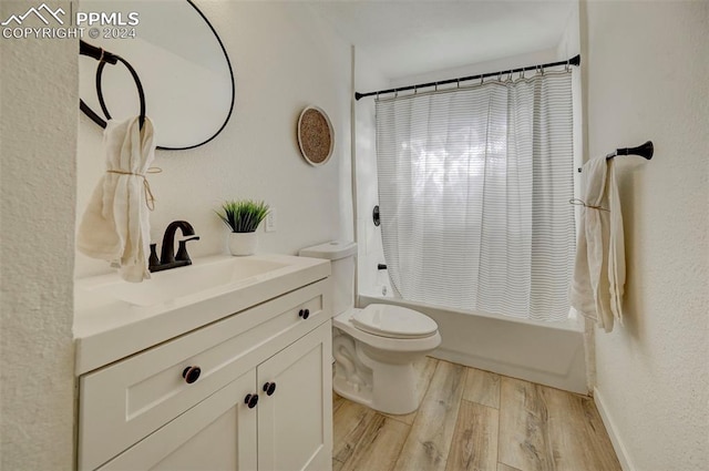 full bathroom with vanity, toilet, hardwood / wood-style floors, and shower / bath combination with curtain