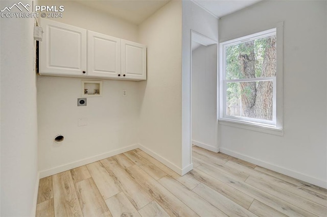 laundry room with washer hookup, light hardwood / wood-style flooring, cabinets, and hookup for an electric dryer