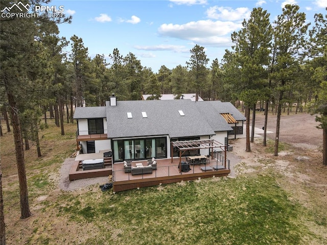 back of property with a wooden deck