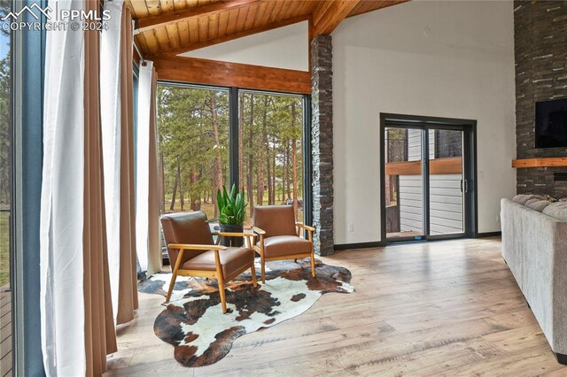 sunroom with lofted ceiling with beams and wood ceiling