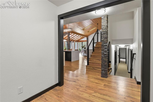 interior space with light wood-type flooring, wood ceiling, and vaulted ceiling with beams