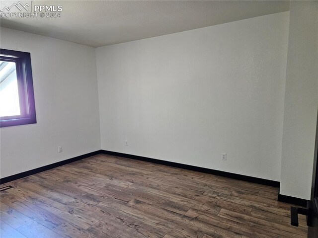 empty room featuring dark wood-type flooring