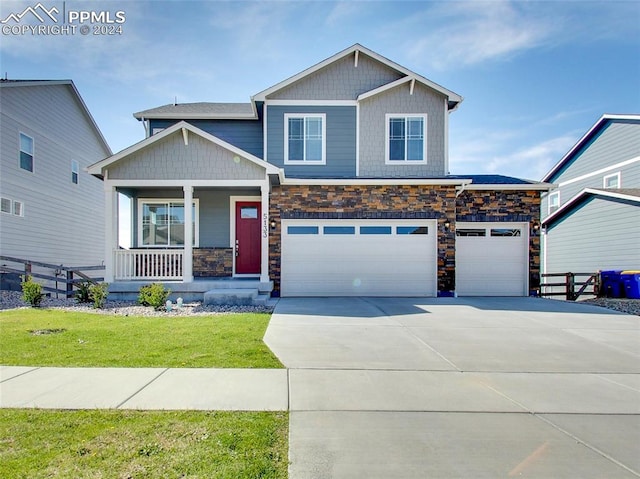 craftsman inspired home featuring a front yard, covered porch, and a garage