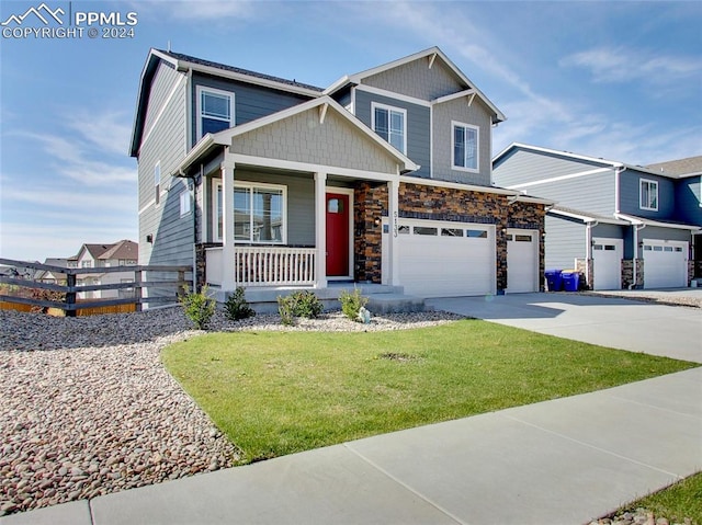 craftsman house with a front yard and covered porch