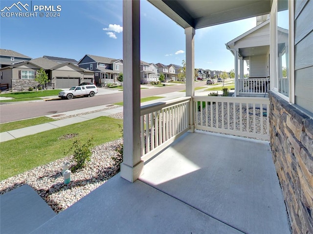 view of patio / terrace featuring a garage and a porch