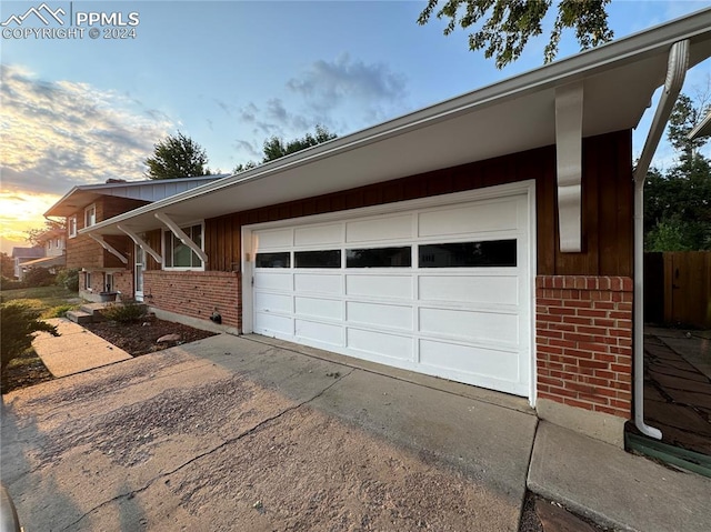 property exterior at dusk featuring a garage