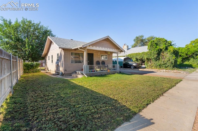 bungalow-style house featuring a front lawn and covered porch