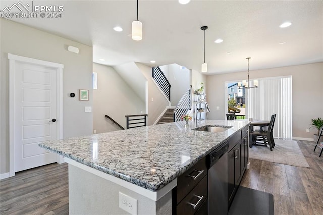 kitchen featuring sink, wood-type flooring, pendant lighting, a center island with sink, and stainless steel dishwasher