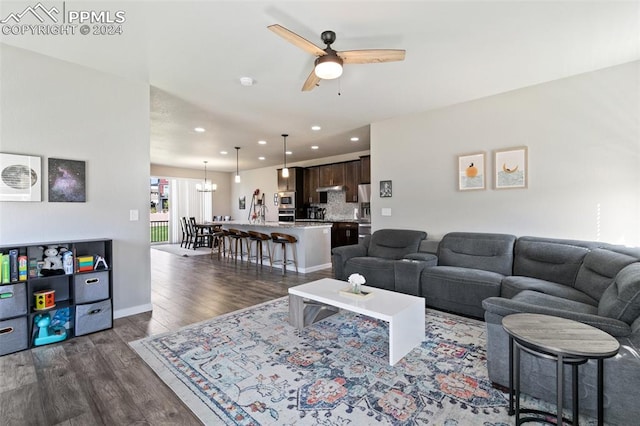 living room with ceiling fan and dark hardwood / wood-style floors