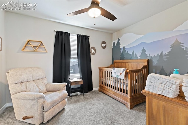 bedroom featuring carpet, a nursery area, and ceiling fan