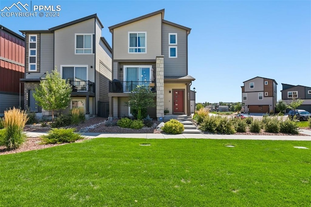 view of front of house featuring a balcony and a front yard