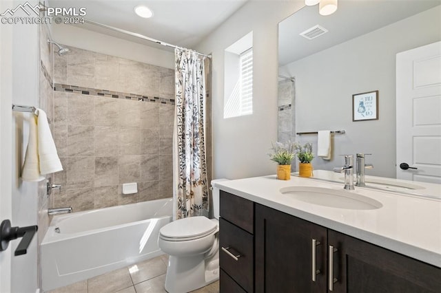 full bathroom with tile patterned floors, shower / bath combination with curtain, toilet, and vanity