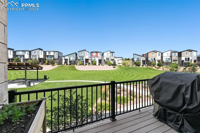 wooden terrace with area for grilling and a lawn