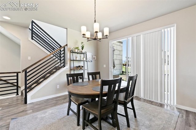 dining room with a chandelier and light hardwood / wood-style floors