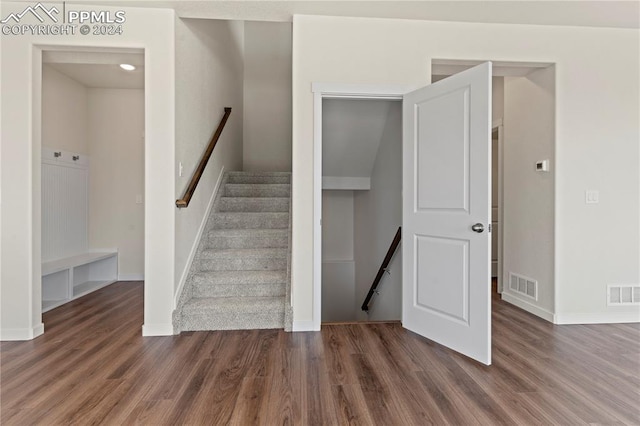 stairs featuring hardwood / wood-style floors