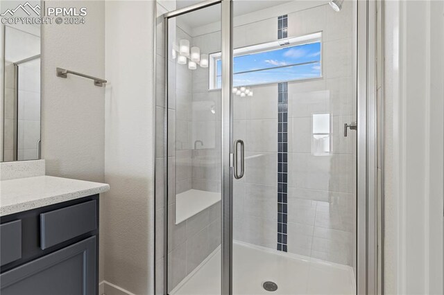 bathroom featuring vanity and an enclosed shower