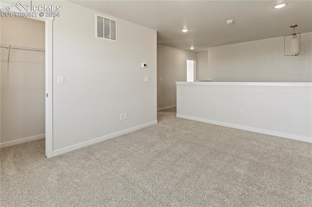 unfurnished room featuring light carpet