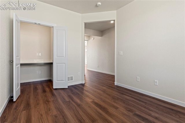 unfurnished bedroom with dark hardwood / wood-style floors