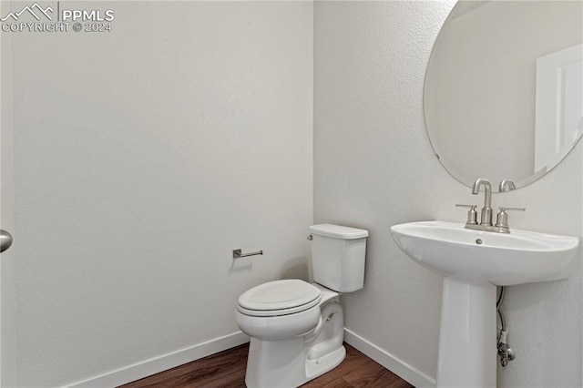 bathroom featuring toilet and wood-type flooring